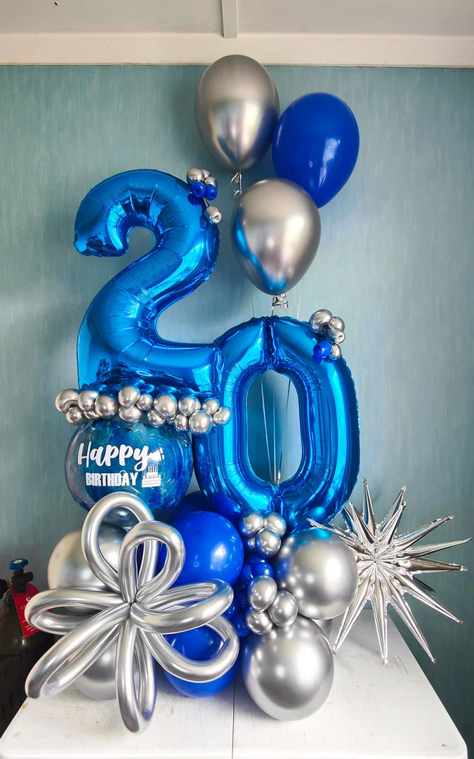 Blue 20 foil number balloons with a Happy Birthday bubble balloon, a silver twisted balloon flower and a silver starburst on a blue and silver balloon base