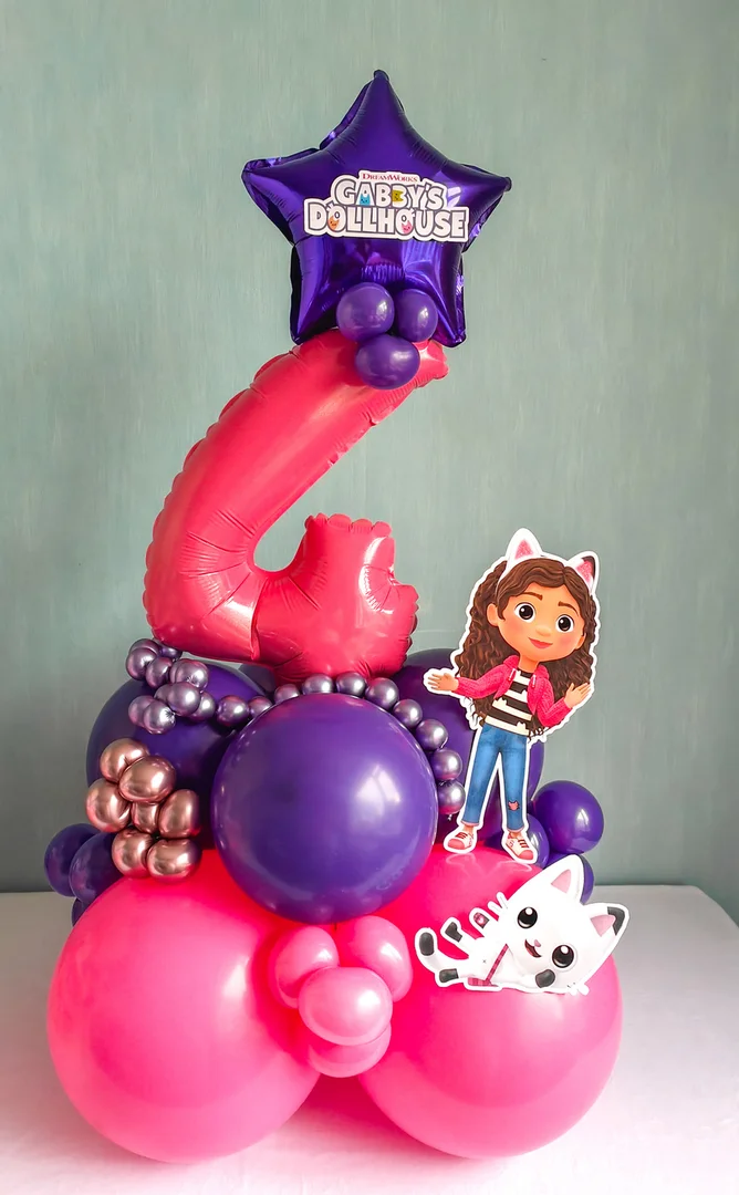 Pink 4 foil number with a purple Gabby's Dollhouse star balloon and character cut-outs on a pink and purple balloon base
