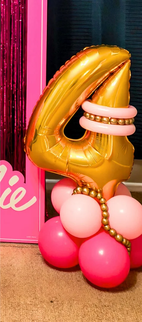 Gold 4 foil number with pink balloon rings and gold bead details on a pink and fuchsia balloon base