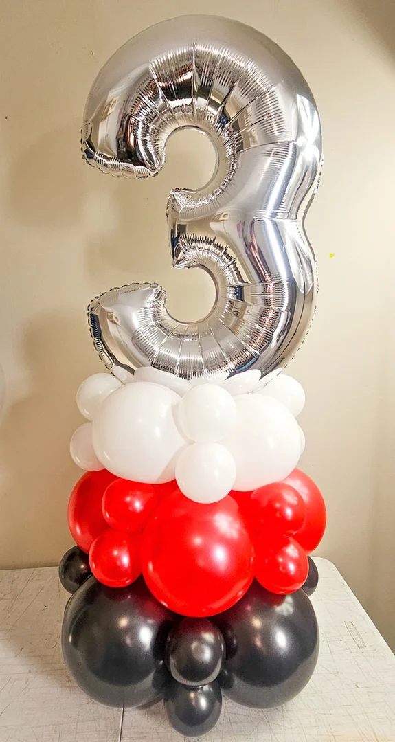 Silver 3 foil number on a column of white, red and black balloons