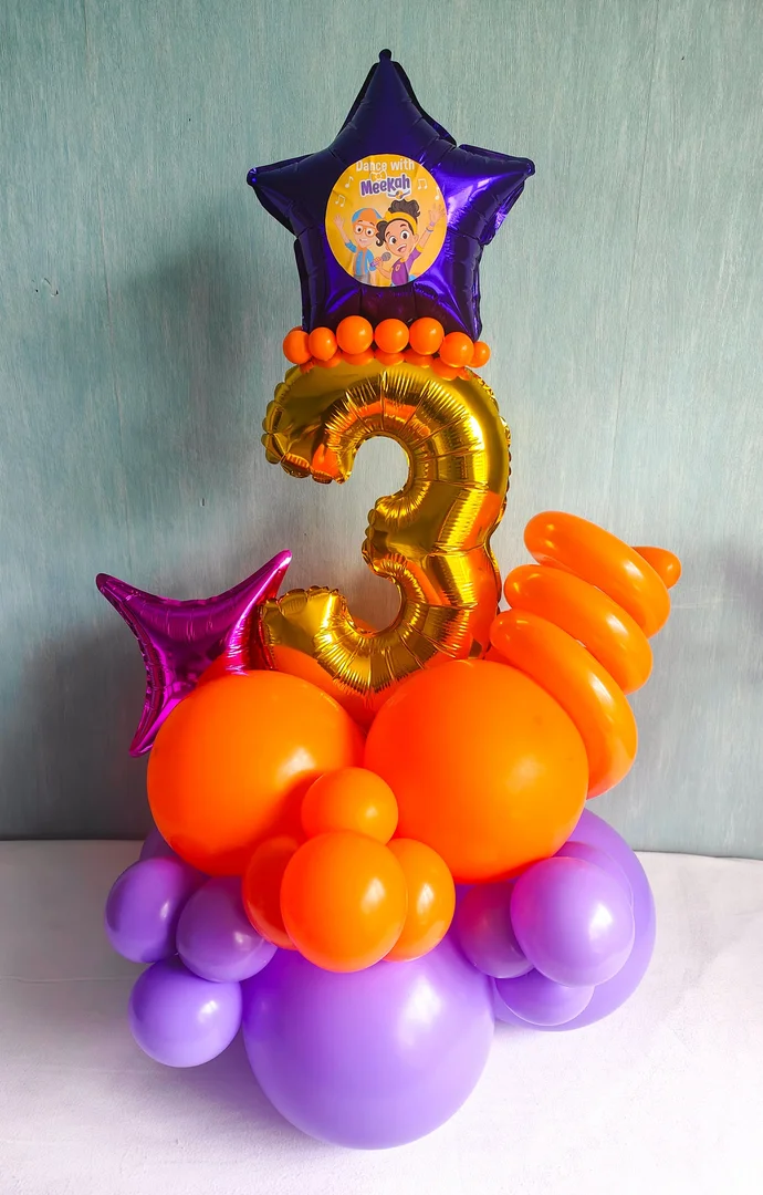 Gold 3 foil number balloon under a purple foil star with a Dance with Meekah character print, with a fuchsia foil star and an orange and lilac balloon base