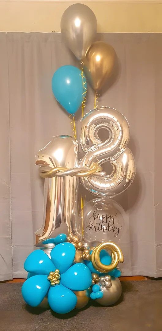 Silver 18 foil numbers with a happy birthday bubble balloon, a teal distortion balloon flower and silver, gold and teal helium balloons