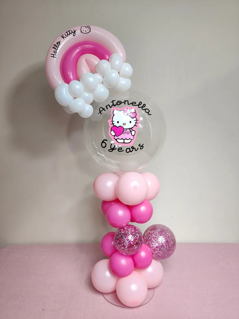 Hello Kitty themed balloon centrepiece with a personalised bubble balloon, a pink balloon rainbow topper and fuchsia confetti balloons
