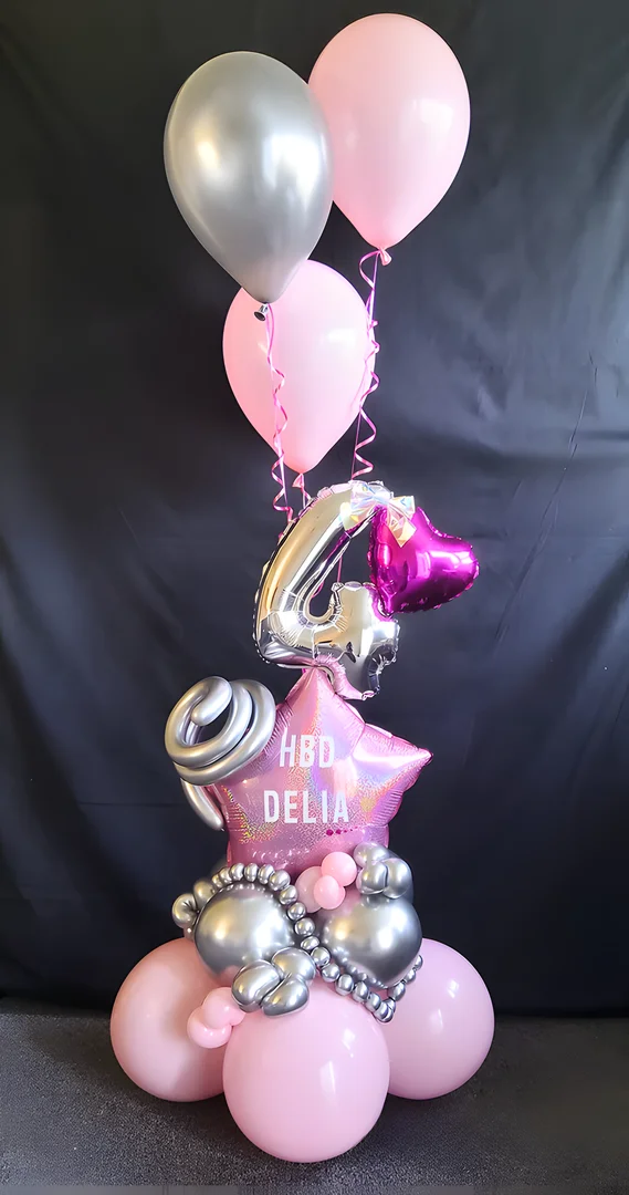 Pink star foil balloon reading HBD Delia with a silver 4 foil number, a fuchsia heart balloon and pink and silver helium balloons